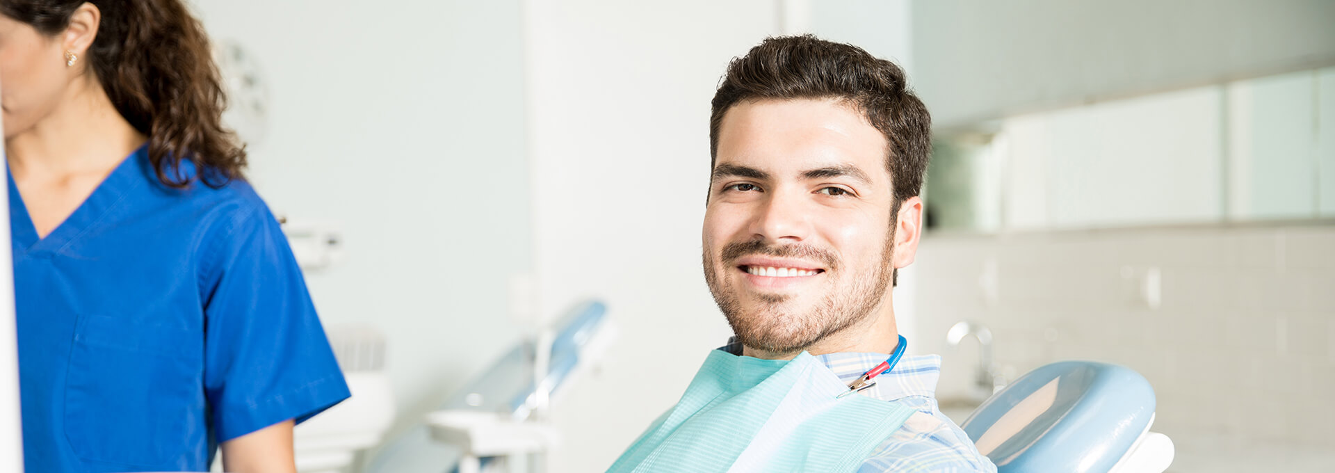 smiling man sitting in a dental chair