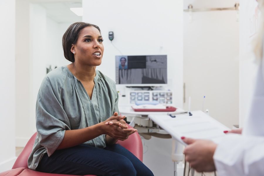 patient talking to dentist about loose crown